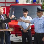 Der Bürgermeister übergibt die Fahrzeugschlüssel zuerst an den Stadtbrandmeister, der sie an den Ortsbrandmeister weitergibt. Klaus-Dieter Schröder beobachtet das erwartungsvoll.